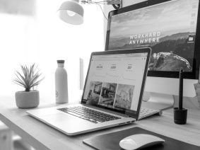Laptop next to a desktop computer