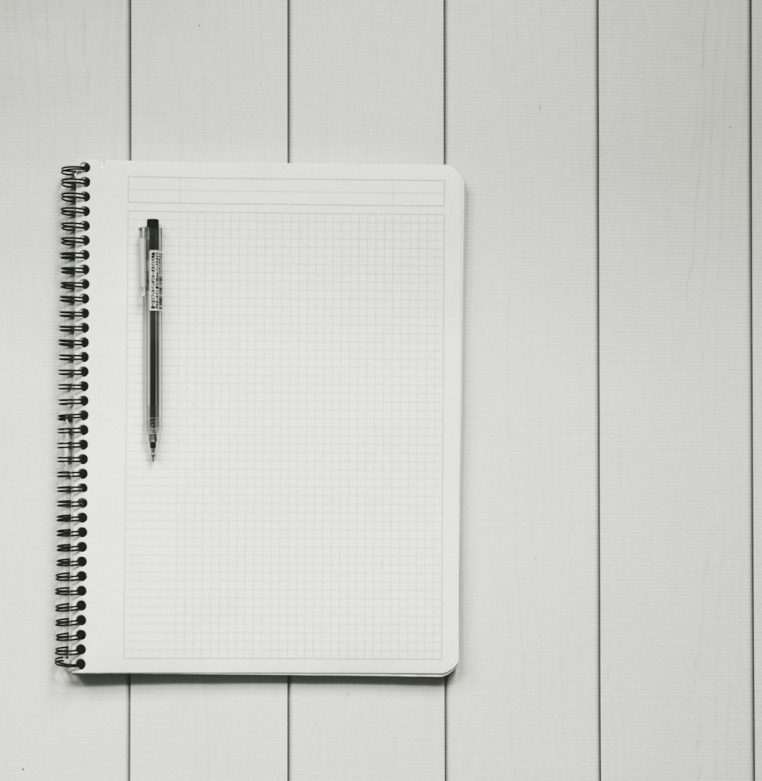 Grid notebook and pen on a desk